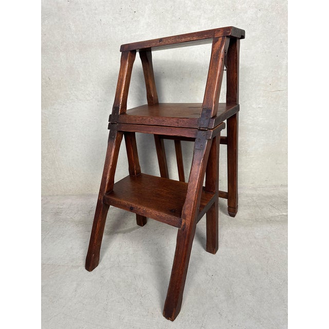 An antique wooden ladder for a bookcase or library cabinet that is slightly too high. Handcrafted. Converts into a chair...