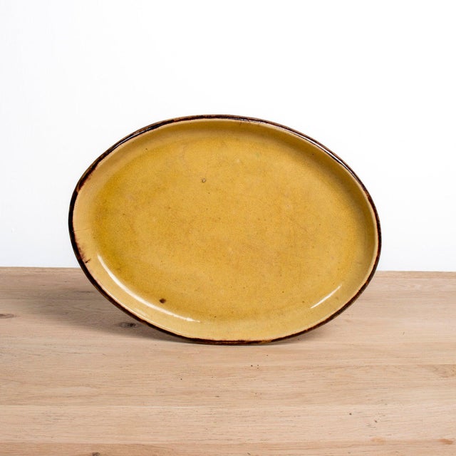 A striking large vintage yellowware oval platter from Dieulefit, a picturesque village in southeastern France with a...