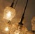 A beautiful mid-century pendant lamp from the 1960s or 1970s. The seven shades are suspended at varying lengths. The...