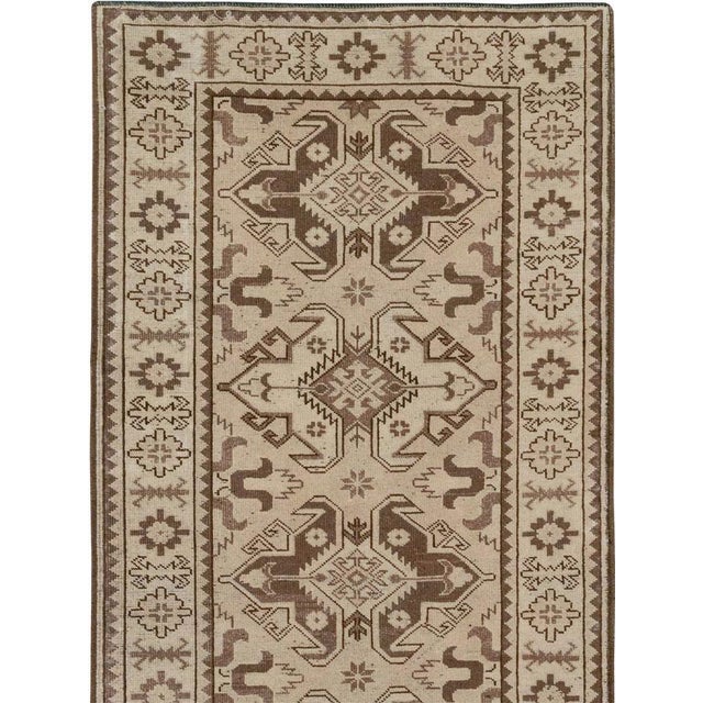 This mid-20th-century Turkish Anatolian long runner presents a highly disciplined procession of alternating geometric...