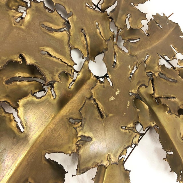 Circa 1960. We offer this Brutalist brass wall sculpture in leaves form, signed by EBANO.