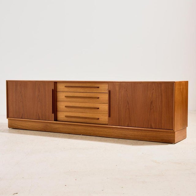 Newly restored teak sideboard with unique handles from the 1960s. This teak beauty has plenty of storage space with two...
