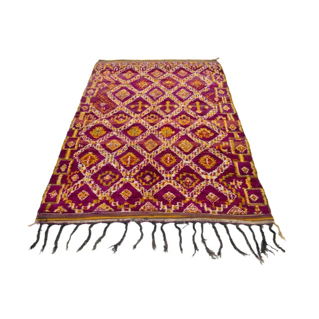 A beautiful, vintage 1960s Moroccan wool rug featuring a purple field adorned with a repeating diamond design. The rug...