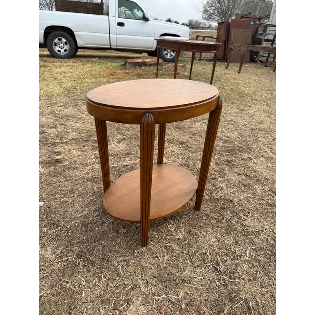 A French Art Deco four legs two-tier accent table, circa 1940s. Made of walnut the wood has been finished with a French...