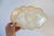Set of two Capiz shell shallow trinket trays with scalloped gold tone edges. Set also includes two coasters. No makers...