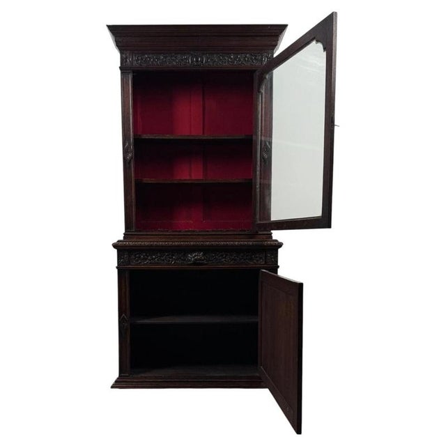 An imposing 19th-century English Victorian bookcase, finely crafted from oak and distinguished by its exceptional carved...