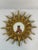 A celestial French Style Gilded Resin Sunburst Wall Mirror from the 1960s. This fabulous 17.25" wall mirror features...