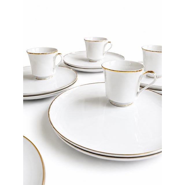 Elegant vintage porcelain dinnerware set originally retailed by Saks Fifth Avenue. This sophisticated Japanese-made set...