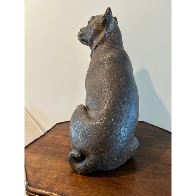 A substantial and expressive seated dog sculpture inspired by traditional Staffordshire terrier forms. Standing 20 inches...