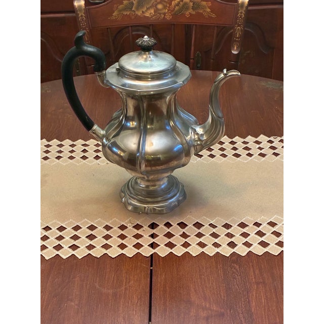 Gourd shaped pewter teapot with ebony handles. Circa 1830 to 1850.