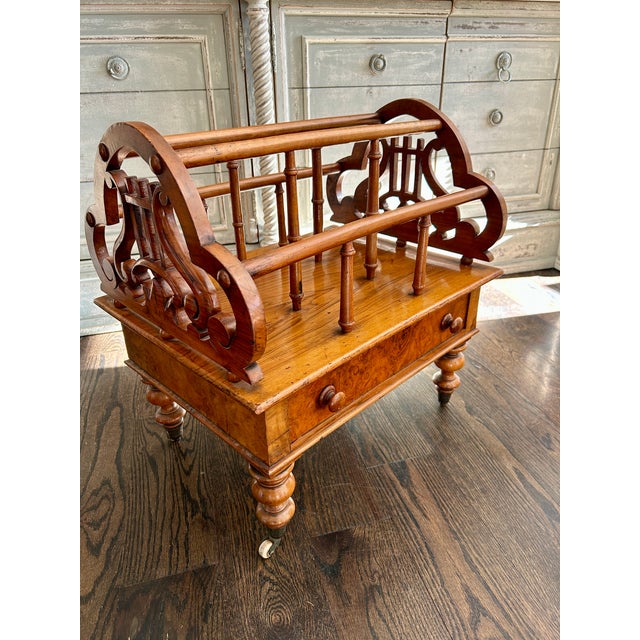 A charming 19th-century Victorian walnut Canterbury, crafted with elegant pierced side panels, turned supports, and a...