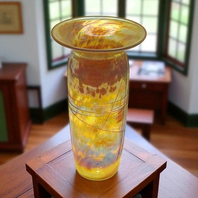 Roger Roland studio handblown art glass vase. Made in the craftsman style, this vase features handblown golden-colored...