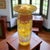 Roger Roland studio handblown art glass vase. Made in the craftsman style, this vase features handblown golden-colored...