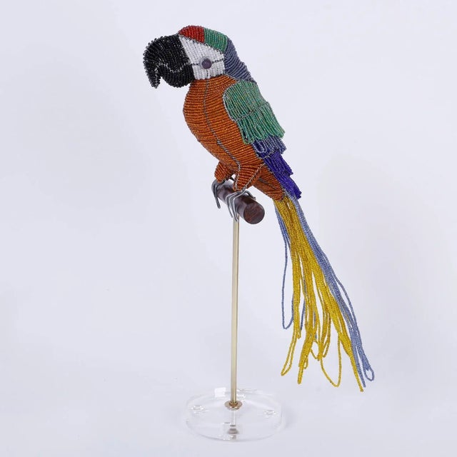 Glass beaded parrot sculpture ambitiously crafted with glass beads and perched on a custom wood, brass, and Lucite stand.