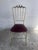 Elegant vintage Chiavari-style chair dating from the 1970s. The slender brass frame features an ornate openwork backrest...