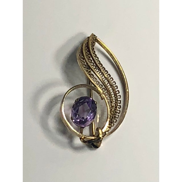 This stunning 1950s Amethyst 14k Gold Filled Brooch will be a lovely jewelry accent on any lapel or scarf. The intricate...