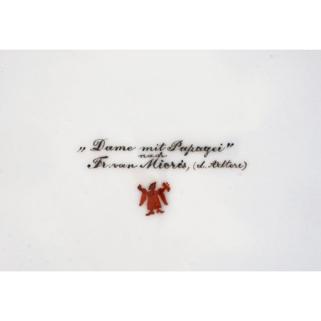 An exceptional late 19th-century Vienna-style cabinet plate richly decorated with a finely hand-painted central scene of a...