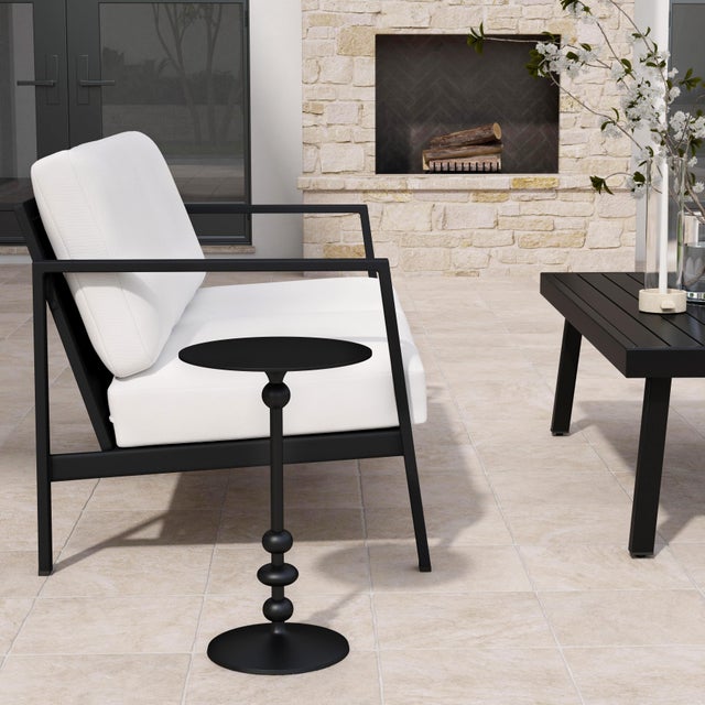 Smooth rounded curves seemingly emanate from the base of this round outdoor side Table. Coupled with a matte black finish,...