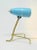 This lamp can be used as either a wall or a table lamp. The light blue metallic screen and the ease of this lamp by Rupert...