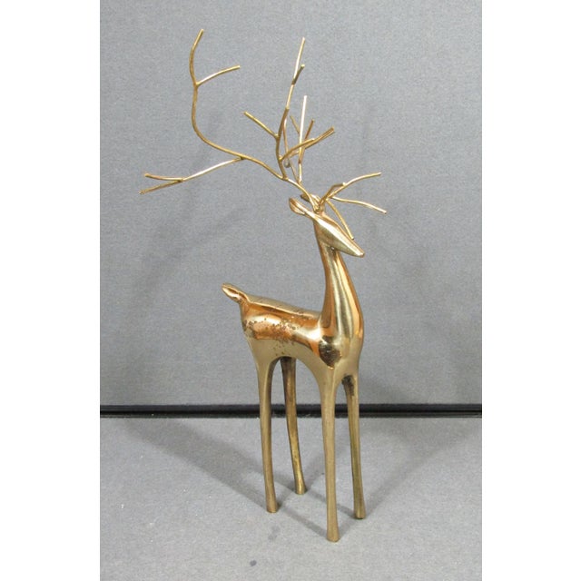 A striking vintage deer sculpture with an elegant, highly stylized modernist silhouette. The elongated body and...