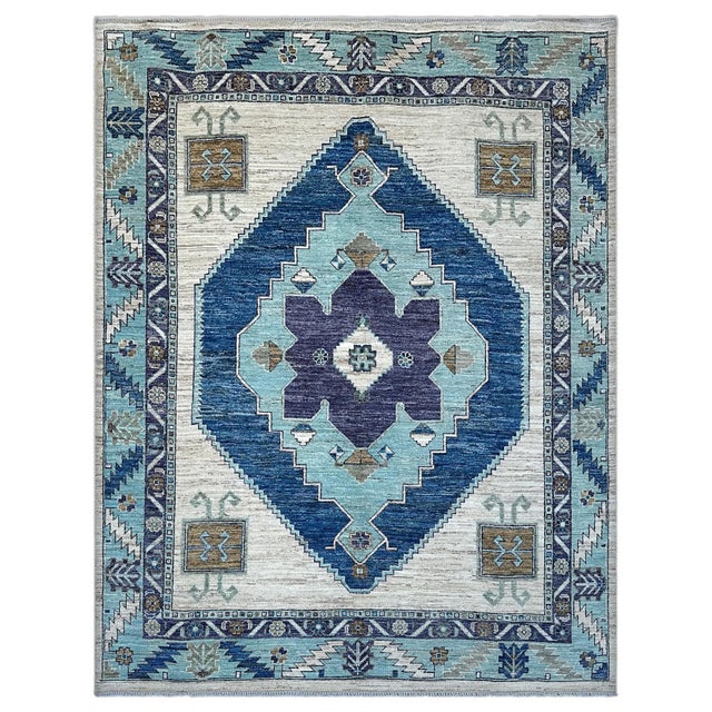 A striking Anatolian medallion area rug, where one bold stepped medallion in deep cobalt, aqua and plum takes over the...