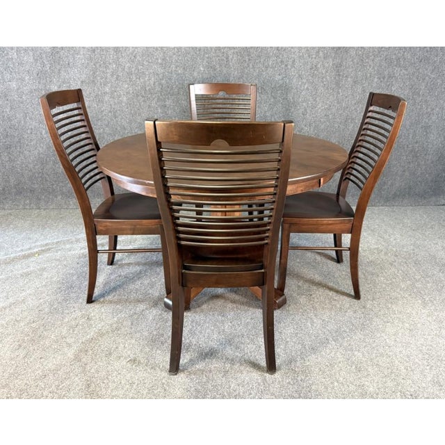 This 5-piece Palettes by Winesburg dining set features a 4-foot round solid wood table with a sturdy pedestal base, paired...