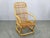 Elegant Mid Century rattan lounge armchair produced in Italy during the 1960s. This beautifully crafted vintage chair...