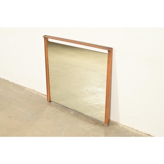 A stylish Mid-Century Modern sculpted walnut framed wall mirror In the manner of George Nakashima By John Van Koert for...