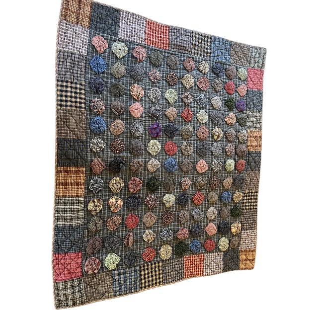 Handmade patchwork quilt with yo-yo (Suffolk puff) appliqué, hand-quilted, with original or early hanging sleeve,...