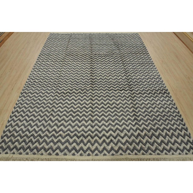 This contemporary geometric Moroccan Chevron rug is hand-knotted with an all-wool high-low pile on a cotton foundation....