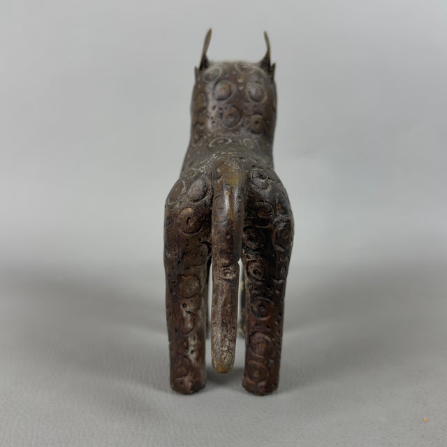 An expressive zoomorphic sculpture in solid cast bronze depicting a leopard, attributed to the 20th-century tribal...