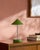 Illuminate your space with a touch of mid-century modern flair, courtesy of the Nomelle accent table lamp. Standing at an...