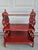 This stylish antiqued red and white three-tiered side table or etagere has graduated shelves. The lowest shelf has a depth...