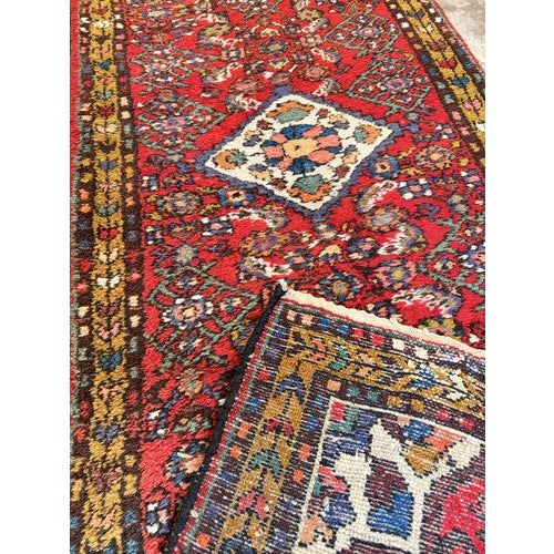 Beautiful semi-antique Hamadan hand-knotted runner in good condition, showing only minor signs of use. Crafted from wool...