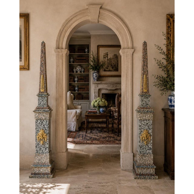 A stunning pair of monumental neoclassical or Grand Tour style solid marble pink, gray, brown, and black obelisks on solid...