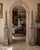 A stunning pair of monumental neoclassical or Grand Tour style solid marble pink, gray, brown, and black obelisks on solid...