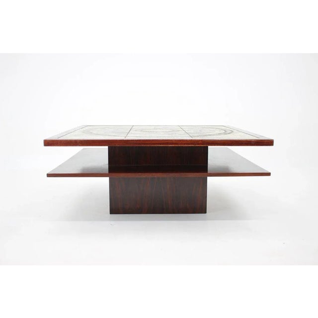 - The item is in good original condition and has been repolished - Signed on one of the tiles. This piece is attributed to...