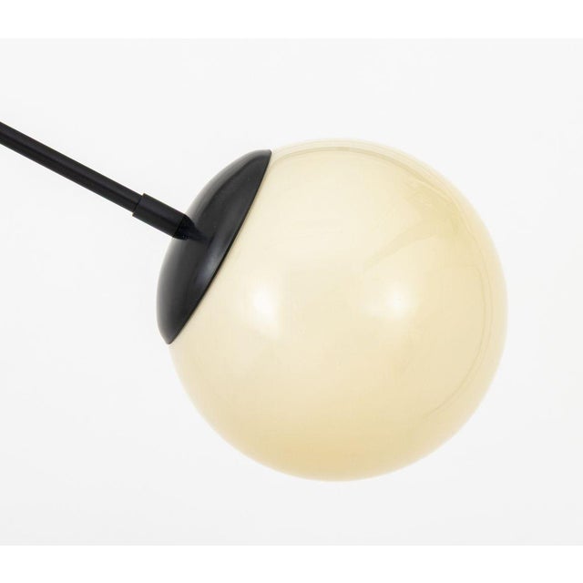 Jason Miller for Roll and Hill "Modo Linear" Pendant Lamp, the patinated black aluminum support with two white glass...