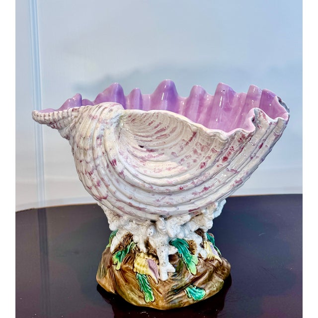A striking antique English ceramic shell-form centerpiece modeled as a large shell resting on coral branches. The...