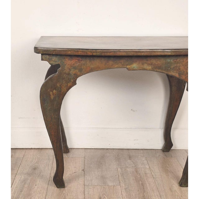 A John Wheatman custom copper top table with four antique legs.