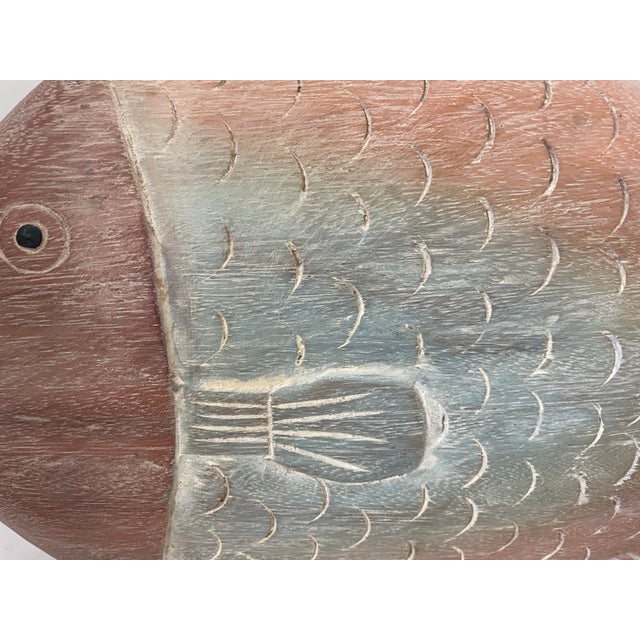 The Large Rustic Carved Wood Fish Sculpture in Tan & Teal is a stunning piece of coastal décor that adds a touch of rustic...
