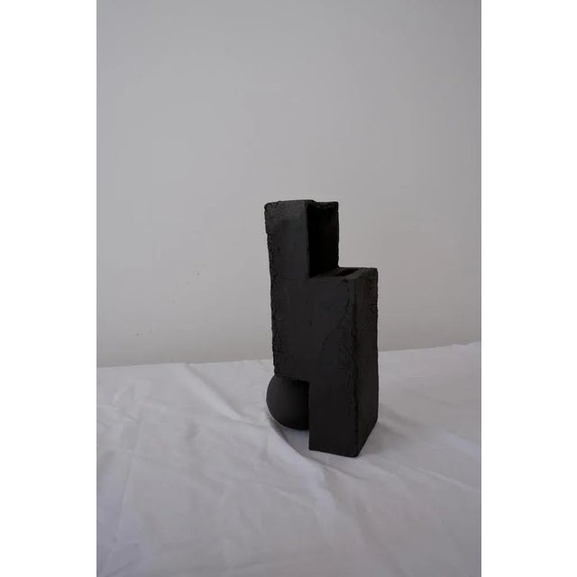 Slide vase by ia kutateladze one of a kind dimensions: w 12 x h 32 cm. Materials: black clay. Handbuilt from black clay....