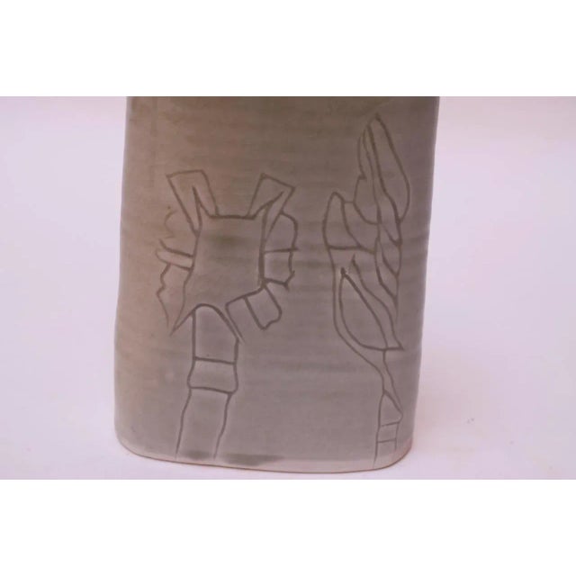 Pale green stoneware vase made in 1976 by ceramicist, Pollack. Abstract floral decoration present on both sides. Signed...