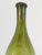 A hand crafted blown glass bottle. Deep green tones. French 19th century.
