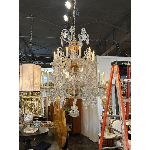 Incredible large scale Venetian twit glass and giltwood 24-light chandelier. Circa 1860. The chandelier has been...