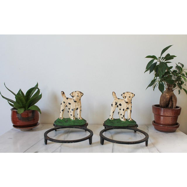 Pair of vintage cast iron Dalmatian dog food and water bowl holders. No makers mark. Age wear to painted finish. Some...