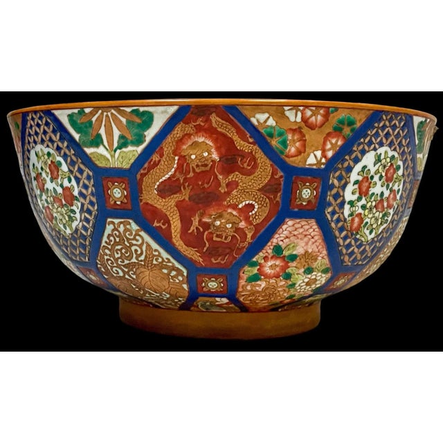 This is a late 20th century large scale Chinese Export style bowl. It has vivid blues and oranges with a dragon motif. It...