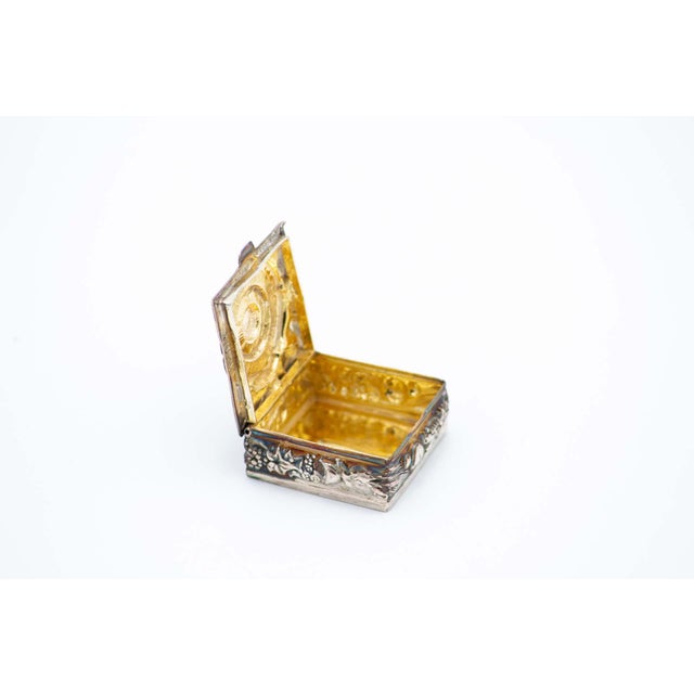 Square Silver Pill Box with Floral Motifs, in Very Good conditions. Designed 1980 to 1989 This piece has an attribution...
