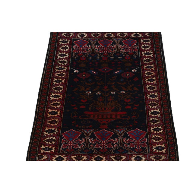 Hand knotted in wool, this 3x4 Baluch scatter rug represents a new line of tribal carpets in the Modern Classics...
