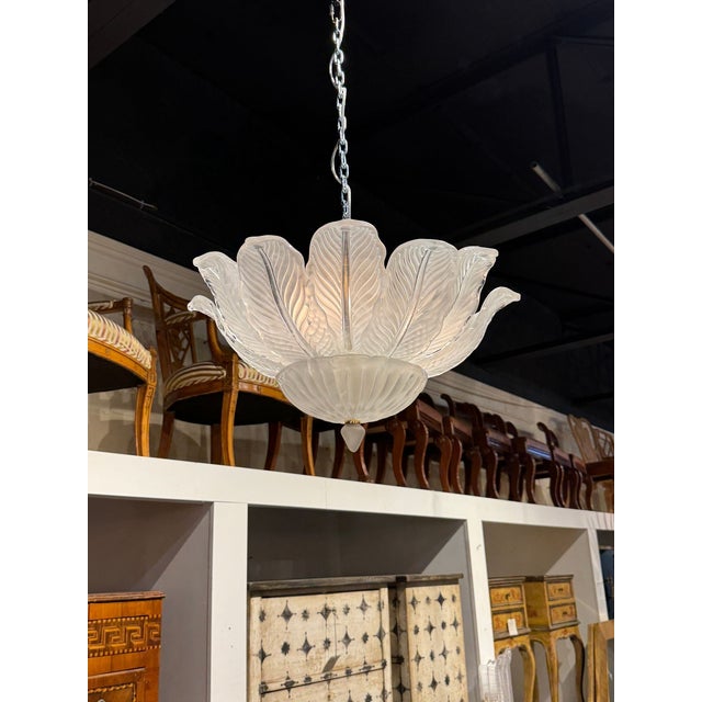 The Murano Frost Glass Leaf Flush Mount Chandelier is a warm white fixture featuring sculptural leaves. This fixture...